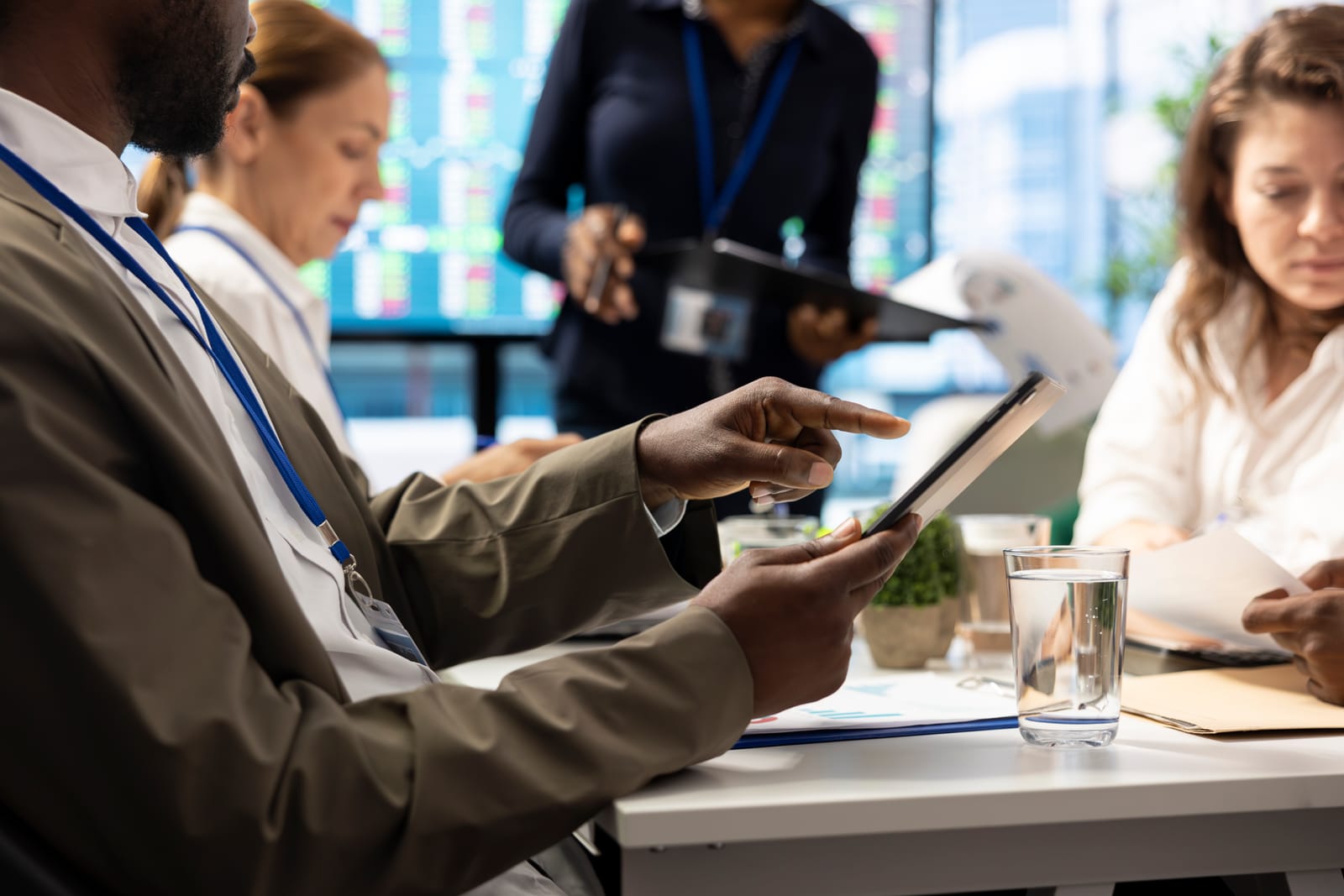 Reviewer examining compliance analytics on a tablet.