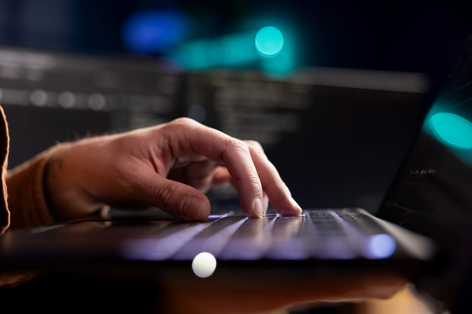 Security researcher examining system vulnerabilities on a laptop.